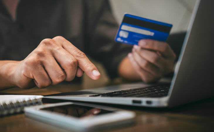 Businessman holding credit card and typing on laptop for online shopping and payment makes a purchase on the Internet, Online payment, Business financial and technology.