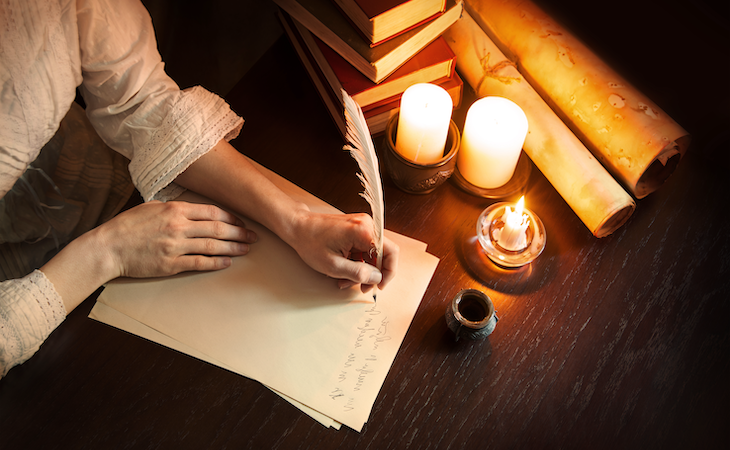 person writing sleep quotes on piece of paper with quill