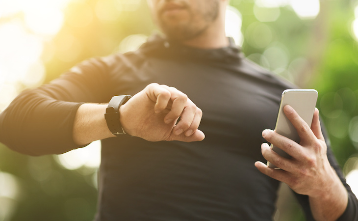 person looking at fitness tracker for biohacking