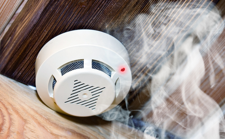 White smoke detector in wooden room