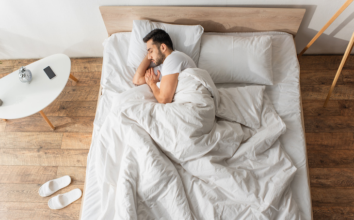 person sleeping on side in bed