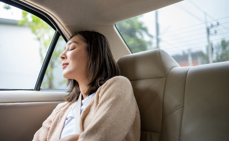 person sleeping in backseat of car