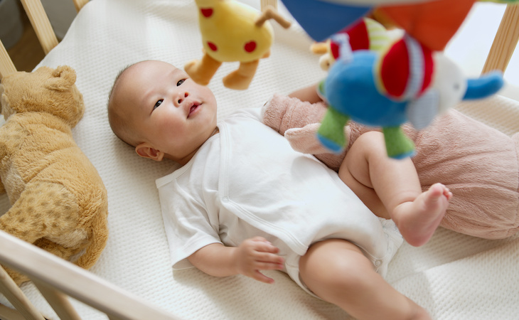 baby lying in crib trying to sleep