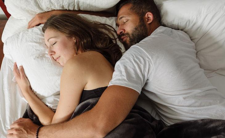 couple sleeping together in bed