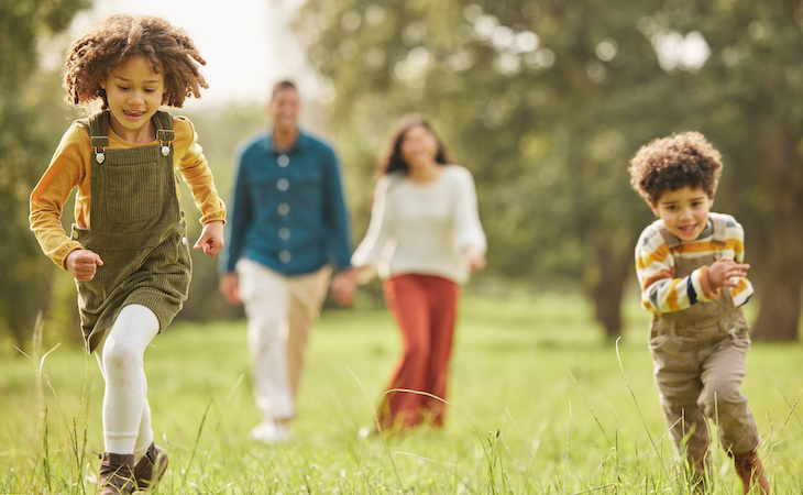 kids and parents running in park and having fun