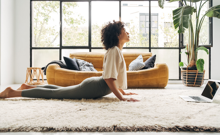 person doing yoga following an online video