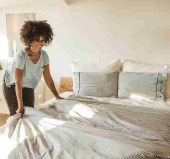 woman making her new bed iStock 1024724962