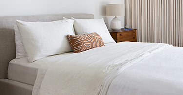 Bed with Saatva sheets.