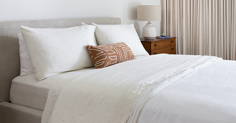 Bed with Saatva sheets.