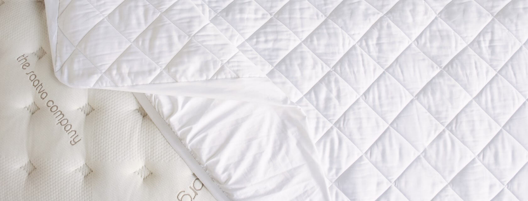 View from the top of a Saatva mattress pad on a Saatva mattress.