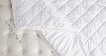 View from the top of a Saatva mattress pad on a Saatva mattress.