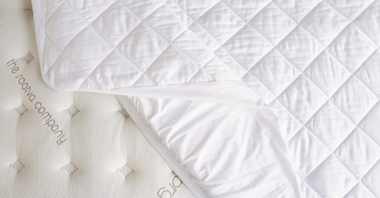 View from the top of a Saatva mattress pad on a Saatva mattress.