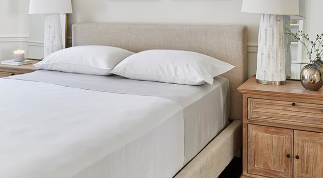A made room with Saatva sheets.
