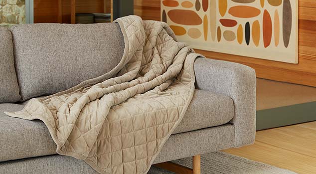 Weighted Blanket laying on a couch.