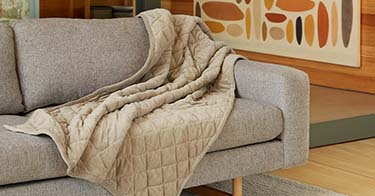 Weighted Blanket laying on a couch.