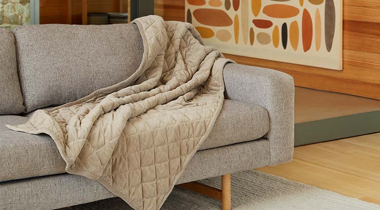 Weighted Blanket laying on a couch.